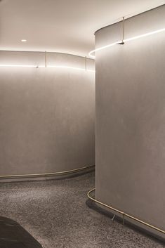 an empty room with two round metal walls