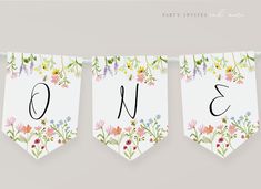 three banners with flowers and numbers hanging from them