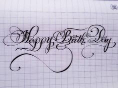 the words happy birthday written in cursive writing on a piece of white paper