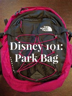 the north face disney 101 park bag is pink and black with white lettering on it