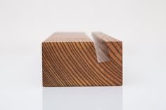 a close up of a wooden object on a white surface with no people around it