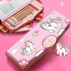 a pink case with unicorns and stars on the side, sitting next to a pencil box