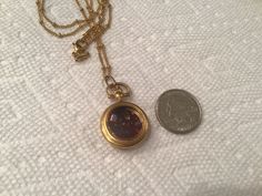 This Vintage pocket watch style Locket is filled with Genuine Garnets. The gems are gorgeous and beautiful quality. The gold-tone locket is from the 1970's. The locket does not open. It will come to you in a gift box. The Perfect gift for that someone special in your life! Orjust treat yourself! Custom orders always welcome! Vintage Gold Pocket Watch In Stainless Steel, Yellow Gold Quartz Pocket Watch Gift, Elegant Gold Pocket Watch Gift, Elegant Gold Pocket Watch As Gift, Gold Metal Jewelry With Compass Design, Gold Stainless Steel Formal Pocket Watch, Brass Round Pocket Watch As Gift, Brass Round Pocket Watch Gift, Gold Metal Pocket Watch As Gift