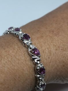 This pink Tourmaline bracelet is very lively and bright. The stones are deep colors and well matched. The sterling silver is plated with rhodium to protect the bracelet from tarnish and give the appearance of white gold. 7.5 inches My jeweler can shorten this for a $10 fee All jewelry is shipped in a nice gift box. Check out our over a THOUSAND great reviews Engraving is $4 per letter and is not always perfect depending on the piece. It can take a few days if the jeweler is busy. This is payable Silver Tennis Bracelet, Tourmaline Bracelet, Vintage Jewels, Deep Colors, Tennis Bracelet, Pink Tourmaline, Chain Link Bracelet, Pandora Charm Bracelet, Vintage Rings