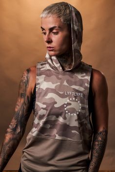 Hooded Two performance panels Antibacterial and anti-odor technology Triple-blend fabric Loose fitting Scoop neck design Polyester/Elastane Our fan favourite is back in a camo series! This women's sleeveless tank top made with our triple-blend fabric provides an antibacterial, anti-odor and sweat-wicking piece – more wear, less wash. This high-tech fabric also holds its shape and is wrinkle-resistant. The loose fitting design has a wide arm opening and hood. Dominate adversity tab paying attenti Athleisure Sleeveless Tops For Streetwear, Athleisure Sleeveless Streetwear Top, Sleeveless Athleisure Tops For Streetwear, Stretch Athleisure Tank Top For Streetwear, Sporty Tank Vest For Streetwear, Functional Sleeveless Vest For Streetwear, Stretch Sleeveless Vest For Streetwear, Athleisure Tank Top For Streetwear, Sporty Sleeveless Activewear For Streetwear