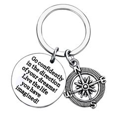 a keychain with a compass on it that says go confidently in the direction of your dreams