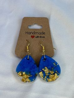 Lightweight transparent blue resin earrings filled with gold flake.  Each earring measures approximately 1 inch across. Gold Flake, Paper Jewelry, Gold Flakes, Resin Earrings, Favorite Jewelry, Jewelry Earrings Dangle, 1 Inch, Etsy Earrings, Dangle Drop Earrings