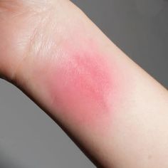 a person's arm with a pink substance on it