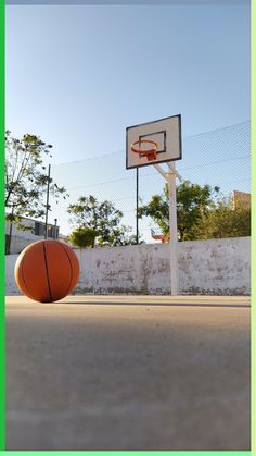 an orange basketball sitting on top of a basketball court