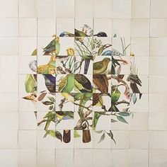 a wall with birds painted on it and green leaves in the middle, surrounded by white tiles