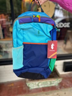 From Cotopaxi:"Bike rides to class, hikes to your favorite lake, or bus rides to wild corners of the world—wherever you’re headed and however you’re going, the Bogota 20L Backpack is here to keep your essentials in check. The 15” laptop sleeve keeps your tech safe while the breathable back panel and shoulder straps keep you cool." After selecting a color type, the second image will be of the back of the item chosen. For more photos you may text or call us at (229) 421-9386. Internal laptop sleev Blue Nylon Backpack For Hiking, Blue Outdoor Backpack With Water Bottle Pocket, Blue Nylon Backpack For Adventure, Blue Waterproof Backpack For Hiking, Blue Functional Adventure Backpack, Blue Backpack With Water Bottle Pocket For Outdoor Activities, Blue Backpack With Water Bottle Pocket For Outdoor, Blue Adventure Backpack Standard Shape, Blue Backpack For Adventure And Back To School