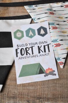 a sign that says build your own fort kit and some other items on the table