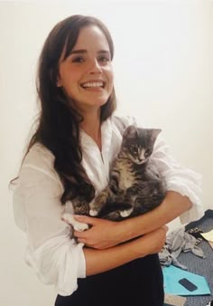 a woman holding a cat in her arms