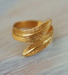 Gorgeous feather 14K Gold plated ring... available ONLY in size: 6 or size 7  Available ONLY in size: 6 (US size) 7 (US size) wide - 1.6 cm = 0.6 inch wide approx. ☆The ring will be shipped in a pretty gift box. ☆There might be slight variations between one piece to the other but it does not indicate any flaw. These are the attributes of handcrafted jewelry. Gold feather ring, delicate ring, gold band, wedding ring, gold wide ring, engagement ring, filigree ring Gold Feather Jewelry For Wedding, Gold Feathered Wedding Jewelry, Bohemian Gold Stackable Rings For Wedding, Adjustable Feather Jewelry For Weddings, Bohemian Gold Stackable Rings For Anniversary, Wedding Ring Gold, Gold Band Wedding Ring, Delicate Gold Ring, Band Wedding Ring