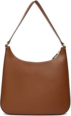 Polished leather shoulder bag in brown. · Fixed shoulder strap · Logo embossed at face · Zip closure · Zip and patch pockets at interior · Suede lining · Silver-tone hardware · H8.5 x W11 x D2.25 in Supplier color: Tan | STAUD Brown Alec Shoulder Bag Rebecca Minkoff Hobo, Leather Shoulder Bag, Patch Pocket, Silver Tone, Shoulder Strap, Shoulder Bag, Collage, Outfit Accessories, Leather