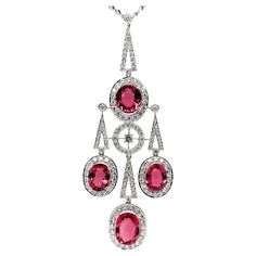 This eye-catching Art Deco style necklace features a beautiful collection of sparkling rubellite tourmaline ovals weighing 14.23 carats total! Over 3.50 carats of brilliant, pave-set diamonds frame the bright pink gems and adorn the various shapes that come together to form this elegant piece. Crafted in 18k white gold, this gorgeous pendant measures approximately 3 inches in length. With the included 18-inch, 18k white gold chain, the bottom of the pendant will sit where a 24-inch chain would s Rubellite Tourmaline, White Gold Sapphire, Pink Gem, Drop Pendant Necklace, Dangle Necklaces, Tourmaline Necklace, Estilo Art Deco, Modern Necklaces, Ring Pendant Necklace