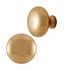 two brass colored knobs are shown on a white background and one is in the shape of a ball