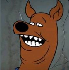 a cartoon dog with big teeth and an evil look on it's face is smiling