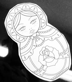 a sticker with an image of a woman's face in the shape of a doll