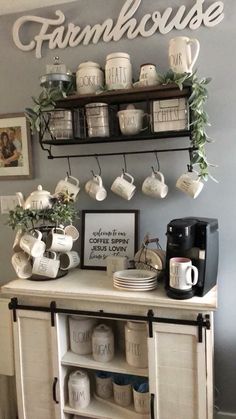 a coffee bar with some cups and mugs on the shelf above it that says farmhouse