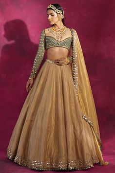 Featuring a gold lehenga in tissue base with sequins and zari hand embroidery. It is paired with a contrasting mud green georgette blouse and a dupatta.  FIT: Fitted at bust and waist. COMPOSITION: Tissue, Georgette. CARE: Dry clean only. Trending Lehnga Designs, Gold Lehenga Simple, Golden Lehenga Simple, Gold Tissue Lehenga, Tissue Lehenga, Golden Lehenga