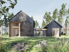 two black houses sitting on top of a lush green field