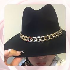 The very stunning Dakota Chain Band Hat is the perfect classy, trending and an absolute must have! The unique curb gold chain accent cowboy hat will surely turn heads! Adding this one-size hat to any outfit can give it just the kind of kick it may need! The chain above the brim adds a special and stylish touch. The soft wool material is desirable without any uncomfortable itch. Pair with a flowy dress, sandals and sunglasses in the summer. Accessorize with over the knee boots and a cardigan for Western Style Gold Fedora With Flat Brim, Trendy Flat Brim Hats For Western-themed Events, Gold Fedora Western Hat, Gold Western Fedora Hat, Western Gold Hat Bands For Party, Western Style Gold Hat Bands For Parties, Gold Flat Brim Hat For Rodeo, Gold Wide Brim Fedora For Party, Gold Fedora Hat For Rodeo