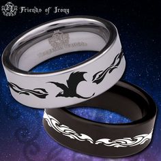 two wedding rings sitting on top of each other in front of a blue sky with stars