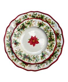 three plates with poinsettis on them are stacked up in the same pattern