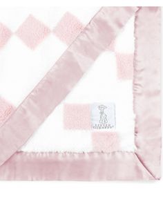 a pink and white checkered blanket with a dog on it's back,