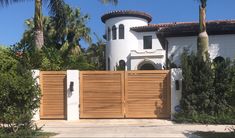 Custom teak louvered driveway gates and columns Driveway Gate Design Modern, Home Loha Gate, Tropical House Gate Design, Modern Gate Design Philippines, Electric Gates Entrance Wood, Modern Resort Entrance Gate Design, House Gates, Low Fence, Wood Gates Driveway