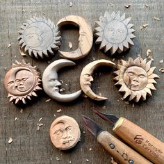 the sun and moon stamps are next to some wood carving tools on a wooden table