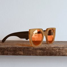 :: Playful, colorful geometry :: - Handmade oversized style sunglasses. - Front: made of traslucent orange acetate with matte finishing.  - Temples: made of hardwood showcasing its natural grain. - The grain always varies, each piece has its own unique grain. - Screw hinges, easy to repair or replace. - Policarbonate tinted lenses color amber, with UV filter and spectrum control. These are luminous leneses, we recommend them for cloudy or mildly sunny days - Includes a chenille pouch and cleanin Orange Mirrored Lenses Cat Eye Sunglasses, Modern Orange Cat Eye Sunglasses With Mirrored Lenses, Modern Orange Wayfarer Sunglasses, Modern Orange Shield Sunglasses With Uv Protection, Modern Orange Tinted Shield Sunglasses, Modern Orange Anti-reflective Shield Sunglasses, Modern Orange Shield Sunglasses With Anti-reflective Coating, Modern Orange Polarized Sunglasses, Modern Orange Sunglasses For Summer