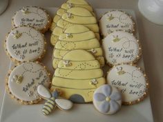 decorated cookies are arranged on a plate with words written in white and yellow frosting