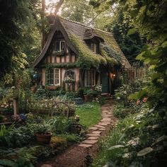 a small house in the middle of some trees and bushes with a pathway leading to it