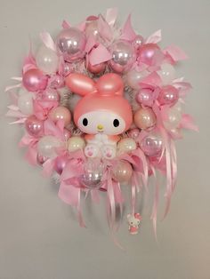 a hello kitty balloon wreath with pink and white balloons in the shape of an animal