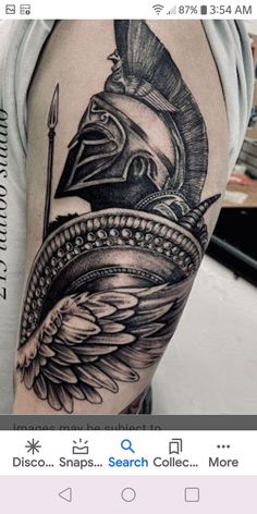 a man's arm with a tattoo on it and an image of a spartan helmet