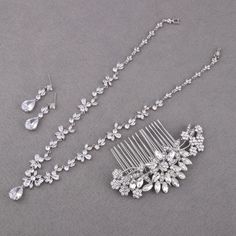 This bridal jewelry set includes a stunning silver necklace, earrings, bracelet, and hair comb, making it a perfect choice for brides and mothers of the bride. Crafted with durable materials, this crystal wedding jewelry is designed to last, and all pieces are nickel- and lead-free for added comfort. Choose your preferred set from the options available.  ✨ Details: CZ NECKLACE: Necklace Length: approx 16 1/2 inches. Materials: cubic zirconia stones & copper, sparkle under lights. CZ EARRINGS: Earring Length about: 1 3/8" (3.5cm) Bottom Teardrop Size: 1/2"H x 3/8"W (1.5cm x 1cm) HAIR COMB: Size: approx width 4 inches (W) by 1 1/2 inches (H).  Materials: clear rhinestones, crystal, ivory pearls,  metal The crystal & pearl hair comb, easy to go with bridal hair styles. CZ BRACELET: Length x W Silver Cubic Zirconia Bridal Necklace For Marriage, Silver Crystal Jewelry For Marriage, Hand-set Silver Bridal Earrings For Marriage, Silver Hand-set Bridal Earrings For Marriage, Silver Bridal Earrings For Marriage, Hand Set Silver Bridal Earrings, Silver Hand Set Bridal Earrings For Marriage, Silver Bridal Sets With Matching Earrings For Wedding, Silver Bridal Accessories With Matching Earrings For Wedding