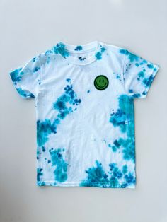 Sky blue and turquoise tie-dye with a smiley face patch to remind you to be happy. Look cool and stay breezy in our Sea Breeze Blue Tie-dye T-Shirt! Featuring a fun tie-dye pattern and a bright blue color, it's sure to make everyone else around feel a little bit more, well, 'happy' to be around you. So, put on the shirt and get ready to turn up the good vibes! #beachvibes These hand tie-dye tee's are made with lots of love from two friends and entrepreneurs in the making! Size: Hanes youth mediu Smiley Face Patch, Turquoise Tie, Bright Blue Color, Fun Tie, Face Patches, Hand Tie, Two Friends, Cool Ties, Sea Breeze