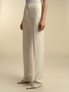 Founded in 2016 by sisters Marina and Francesca Moscone, the label gravitates toward a tactile approach, twisting and draping fabrics by hand to create a softly seductive design using custom jacquards, fil-coupés, and silk wools, all exclusively developed in Italy, rendered in precise shapes and tailoring. These tailored straight trousers sit comfortably on the high hip and low waist. Product Details 72% polyester, 21% viscose, 7% elastane. Center front zip closure. Made in Italy. Care Instructi Italy Fits, Draping Fabric, High Hips, Slim Trousers, Cotton Midi Dress, Straight Trousers, Silk Wool, Color Ivory, Low Waist