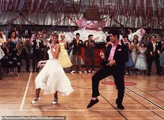 a man and woman dancing on a dance floor in front of a group of people