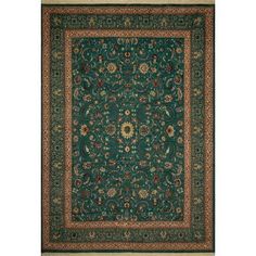 a green rug with an ornate border and floral design on the bottom, in front of a