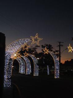 lighted archways with stars on them at night