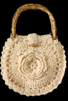 This stunning handmade crochet purse is the perfect blend of craftsmanship and boho-chic style. The intricate flower pattern on the front adds a unique and feminine touch, while the sturdy bamboo handles provide an eco-friendly and stylish feature. Made with soft beige yarn, this round crochet tote is versatile enough for casual outings, beach trips, or brunch with friends. - Unique Floral Design: A beautifully crocheted flower centerpiece gives this handbag a charming and artisanal feel, perfect for those who appreciate handmade accessories. - Eco-Friendly Bamboo Handles: The natural bamboo handles are not only durable but also add a rustic, eco-conscious element to the bag. - Lightweight and Comfortable: Easy to carry, this bag is lightweight yet sturdy, making it ideal for carrying your Elegant Natural Crochet Bag, Bohemian White Crochet Bag Hand Knitted, White Bohemian Crochet Bag Hand-knitted, Vintage Natural Crochet Bag, White Hand Knitted Bohemian Crochet Bag, Beige Traditional Crochet Bag, Handwoven Cream Bohemian Crochet Bag, Vintage Handmade Crochet Bag For Vacation, Handmade Vintage Crochet Bag For Vacation