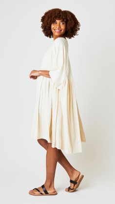 A dramatic one sized dress crafted from the softest hand spun woven cotton. Voluminous, flowing and relaxed silhouette makes a "cool" piece for southeastern fall weather. Heritage styling, raglan elbow length sleeves and densely gather skirt that falls to knee-length. Fabric Content: 100% hand spun, hand woven cotton Care Instructions: Gentle hand wash in cold water. Do not soak. Drip dry in shade. Imported Measurements (Inches) One Size Length 42" Sleeve Length 16" Measurements are approximate. Gather Skirt, Dress Crafts, Fall Weather, Gathered Skirt, Drip Dry, Soft Hands, Elbow Length Sleeve, Woven Cotton, Hand Spinning