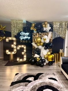 a room decorated with balloons and streamers for a 30th birthday party in black, gold and white