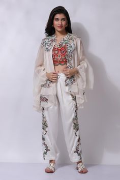 Ivory white floral embroidered jacket. Paired with an inner and embroidered pant.
Components: 3
Pattern: Embroidered
Type Of Work: Chikankari
Neckline: V Neck
Sleeve Type: Flared
Fabric: 25% Silk, 75% Cotton
Color: Ivory,White
Other Details: 
Attached cotton lining
Model Height: 5 ft 7 inches, wearing size M
Closure: Zip
Occasion: Resort - Aza Fashions Traditional White Pant Set For Festive Occasion, White Dupatta For Designer Wear In Spring, Designer White Dupatta For Spring, White Dupatta For Spring Festivals, White Dupatta For Spring Festive Occasions, Spring Designer White Dupatta, Spring Designer Sets With Pearl Embroidery, Festive White Dupatta For Spring, White Spring Festive Dupatta