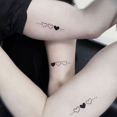 two women with matching tattoos on their legs