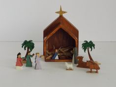 a nativity scene with figurines in the foreground and a star on top