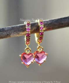 Sweet little earrings featuring fuchsia pink heart charms. The earrings feature cubic paved hoops, that are clicker style. They connect to the tiny crystal heart charms. The heart charms are 7mm and the hoops are 10mm (outer) and 9mm (inner). Total earring length is 3/4". Earrings are 14K gold plated, and nickel and lead free. 4 Earrings, Cartilage Hoop, Everything Pink, Fuchsia Pink, Huggie Hoop Earrings, Crystal Heart, Jewelry Earrings Hoops, Huggies Earrings, Pink Heart